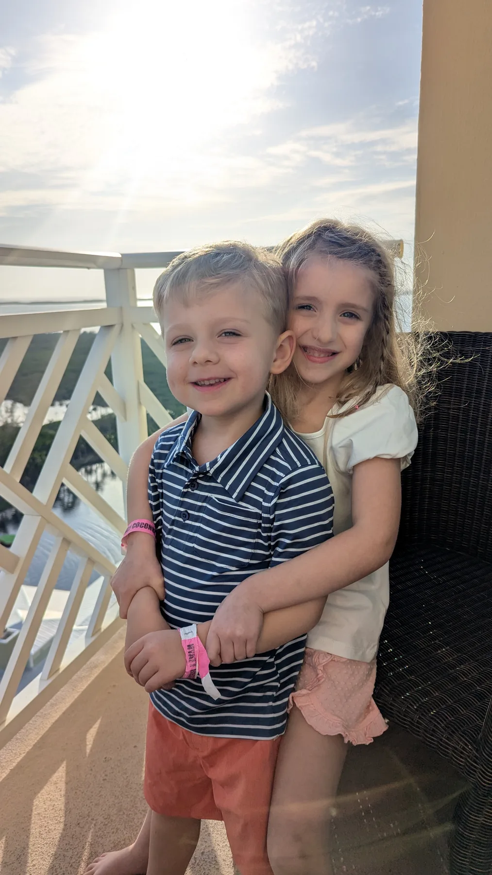 Abigail and Caleb standing together on a balcony at sunset